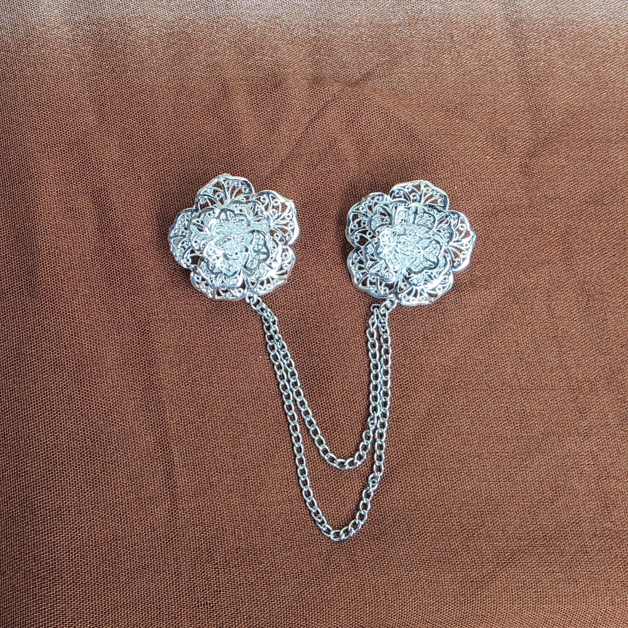 POYA silver rose brooch set with intricate floral filigree design and delicate connecting chains